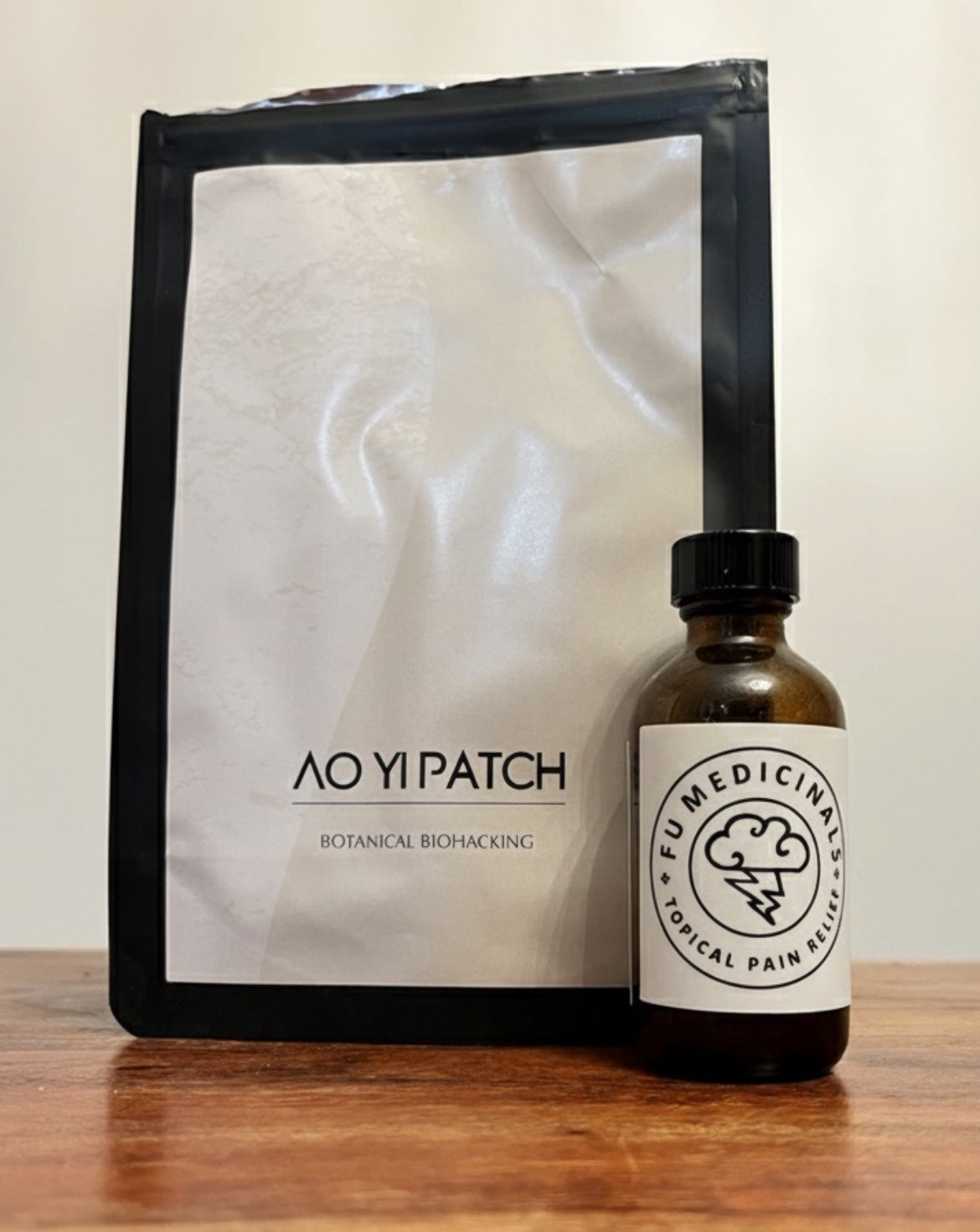 AO YI PATCH package and a bottle labeled 'FUMEDICINALS' on a wooden surface.