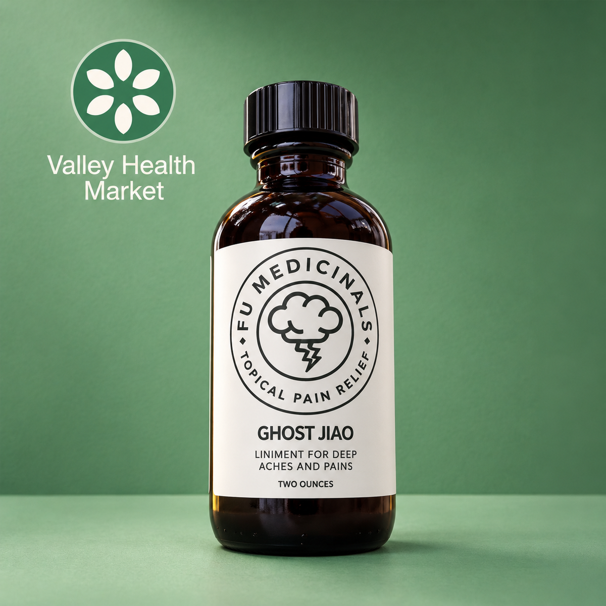 An amber glass bottle of FU Medicinals Ghost Jiao topical pain relief, set against a solid green background with a 'Valley Health Market' logo in the upper left corner.