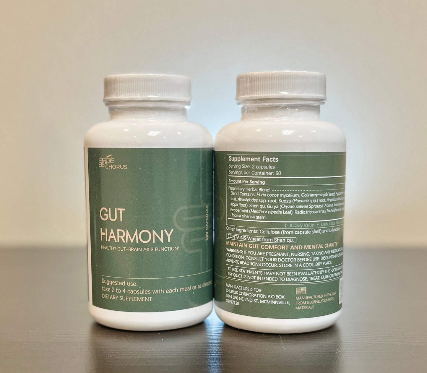 Two bottles of 'Gut Harmony' dietary supplements on a reflective surface with a neutral background.