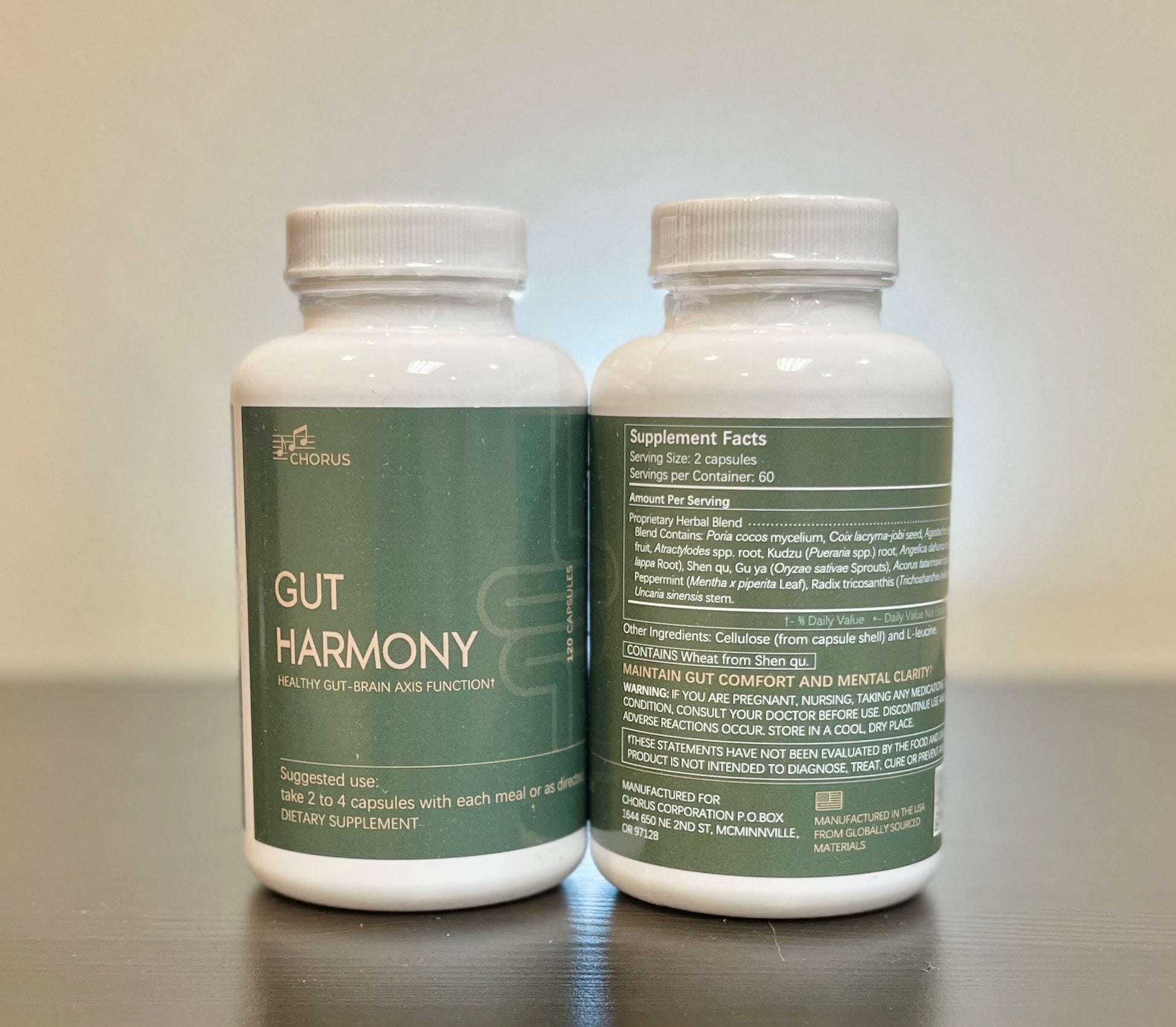 Two bottles of 'Gut Harmony' dietary supplements on a reflective surface with a neutral background.