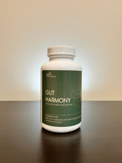 Supplement bottle labeled 'Gut Harmony' on a reflective surface with a neutral background