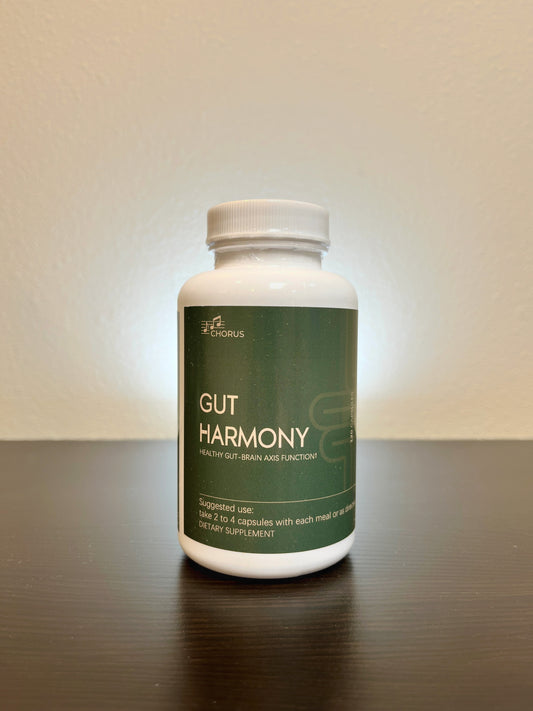 Supplement bottle labeled 'Gut Harmony' on a reflective surface with a neutral background