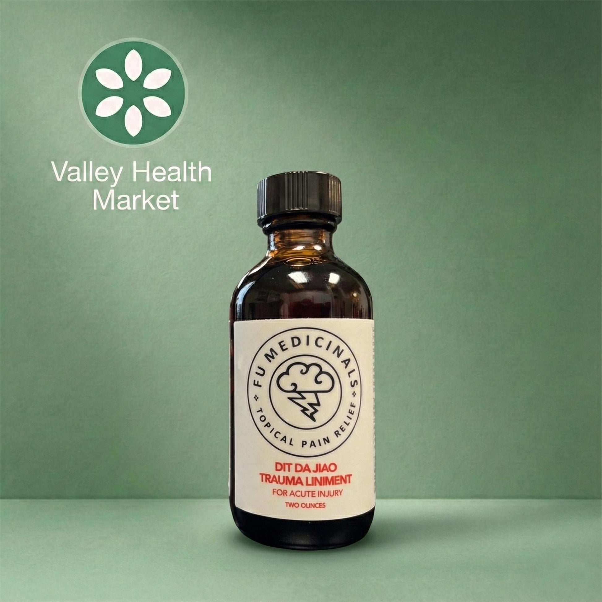 Bottle of PNW Dit Da Jiao Trauma Liniment with Valley Health Market logo on a green background