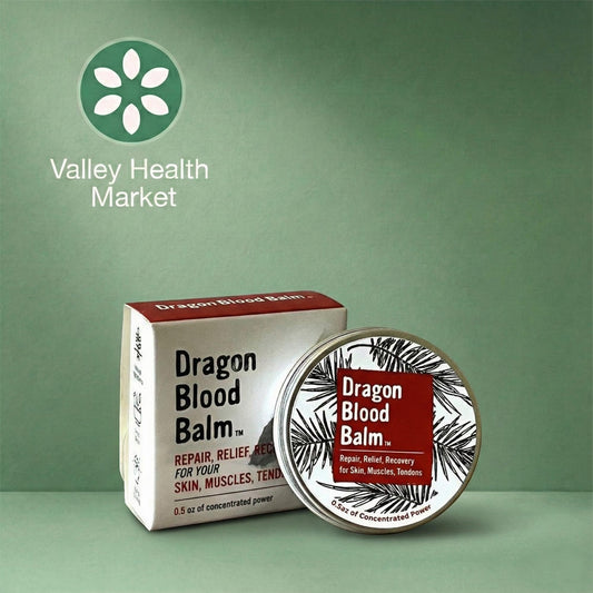 Dragon Blood Balm packaging with box and tin on a green background, featuring Valley Health Market logo.