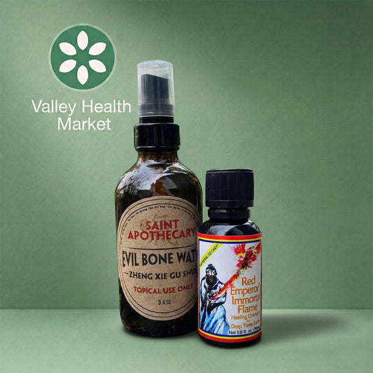 Two bottles of Saint Apothecary's Evil Bone Water and Red Emperor Immortal Flame products on a green background with Valley Health Market logo.