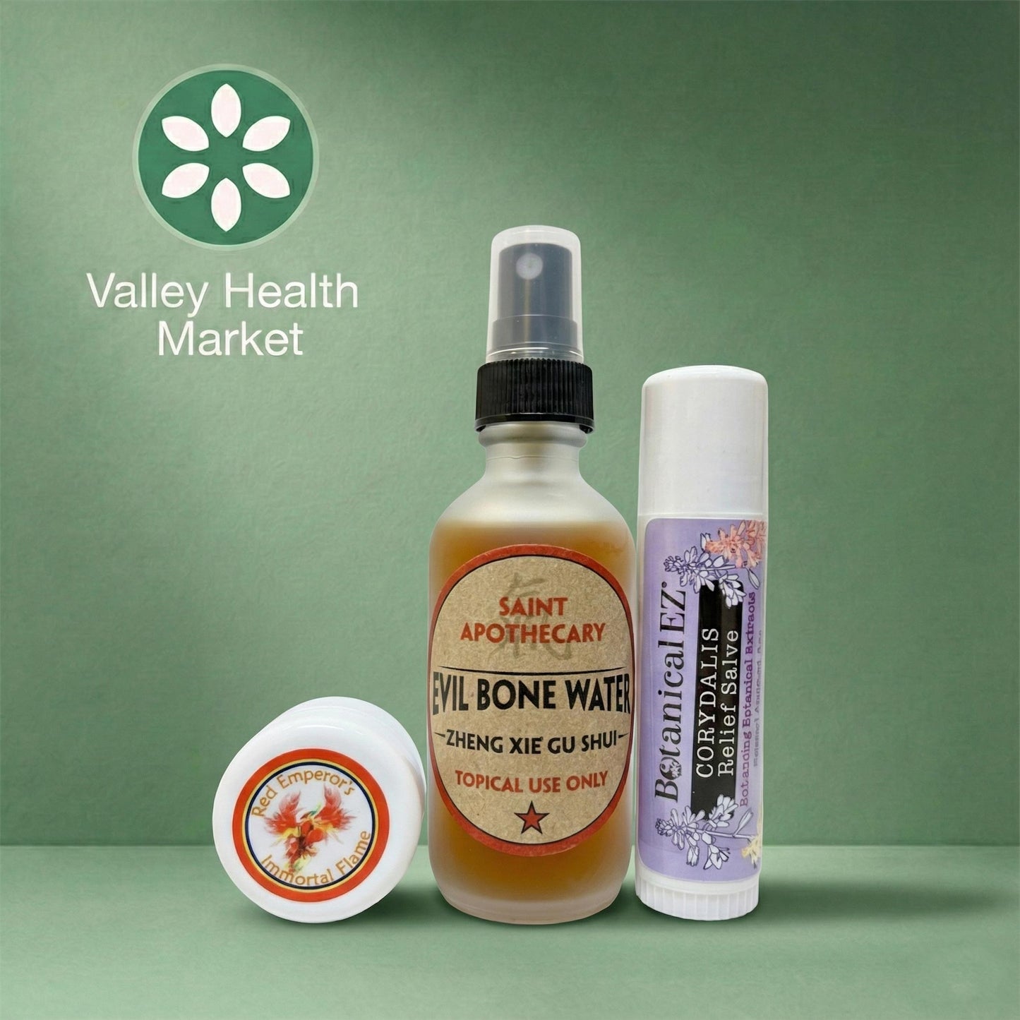 Red Emperor's Immortal Flame, Evil Bone Water and Corydalis Relief Salve sample sizes with labels on a green background, featuring the Valley Health Market logo.